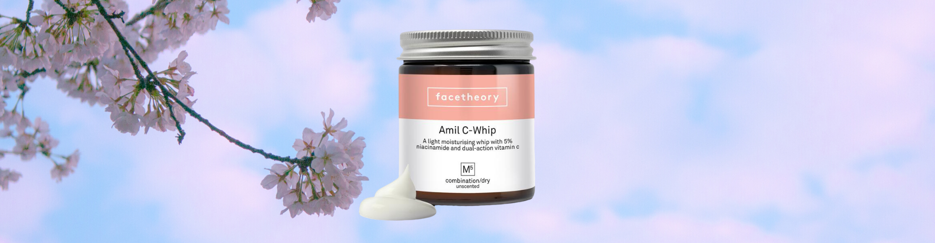 Facetheory amil-c whip review - photo of the moisturiser with a cherry blossom background.