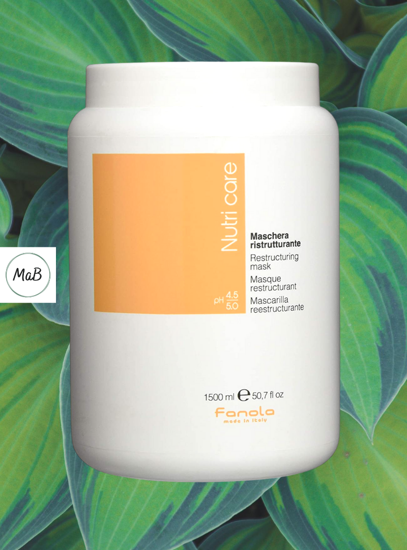 A photograph of a tub of fanola nutricare hair mask with hosta leaves in the background