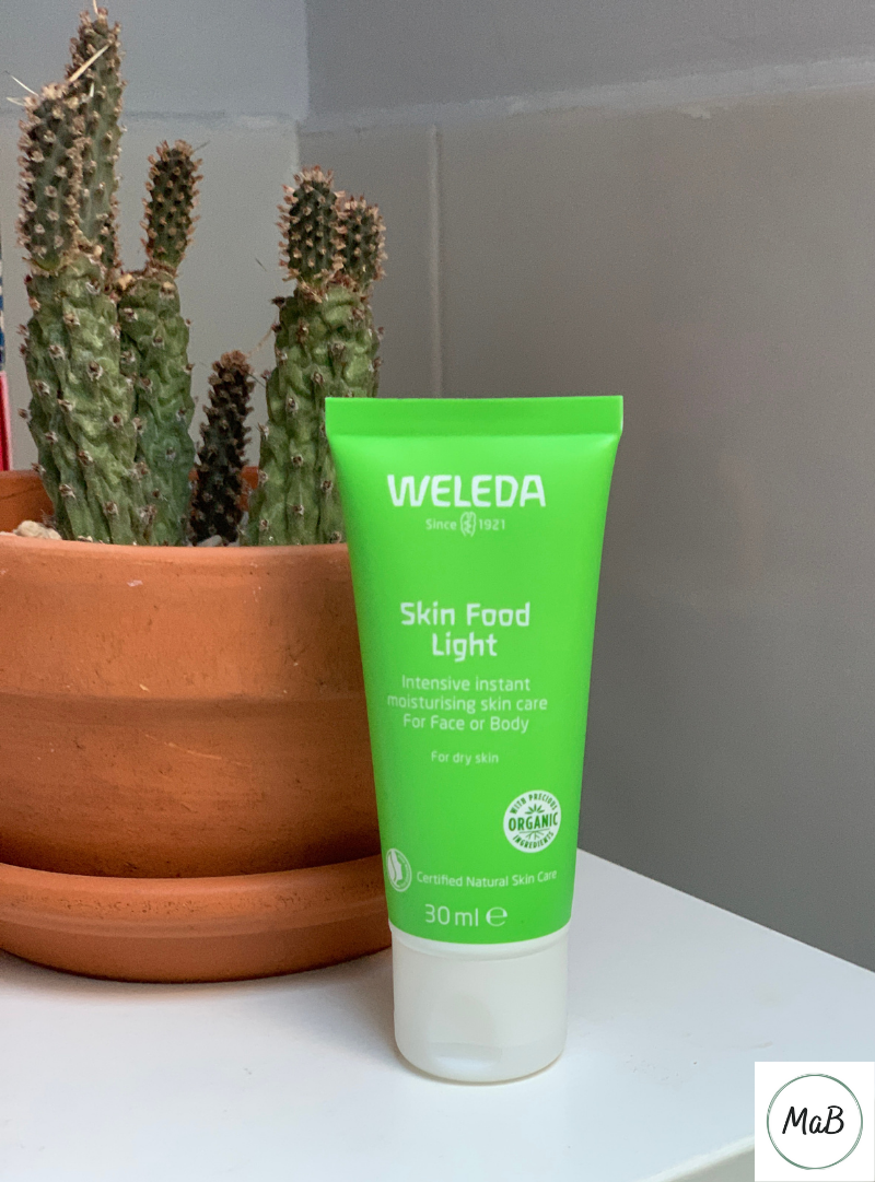 A photograph of a tube of Weleda Skin Food on a bathroom cabinet.